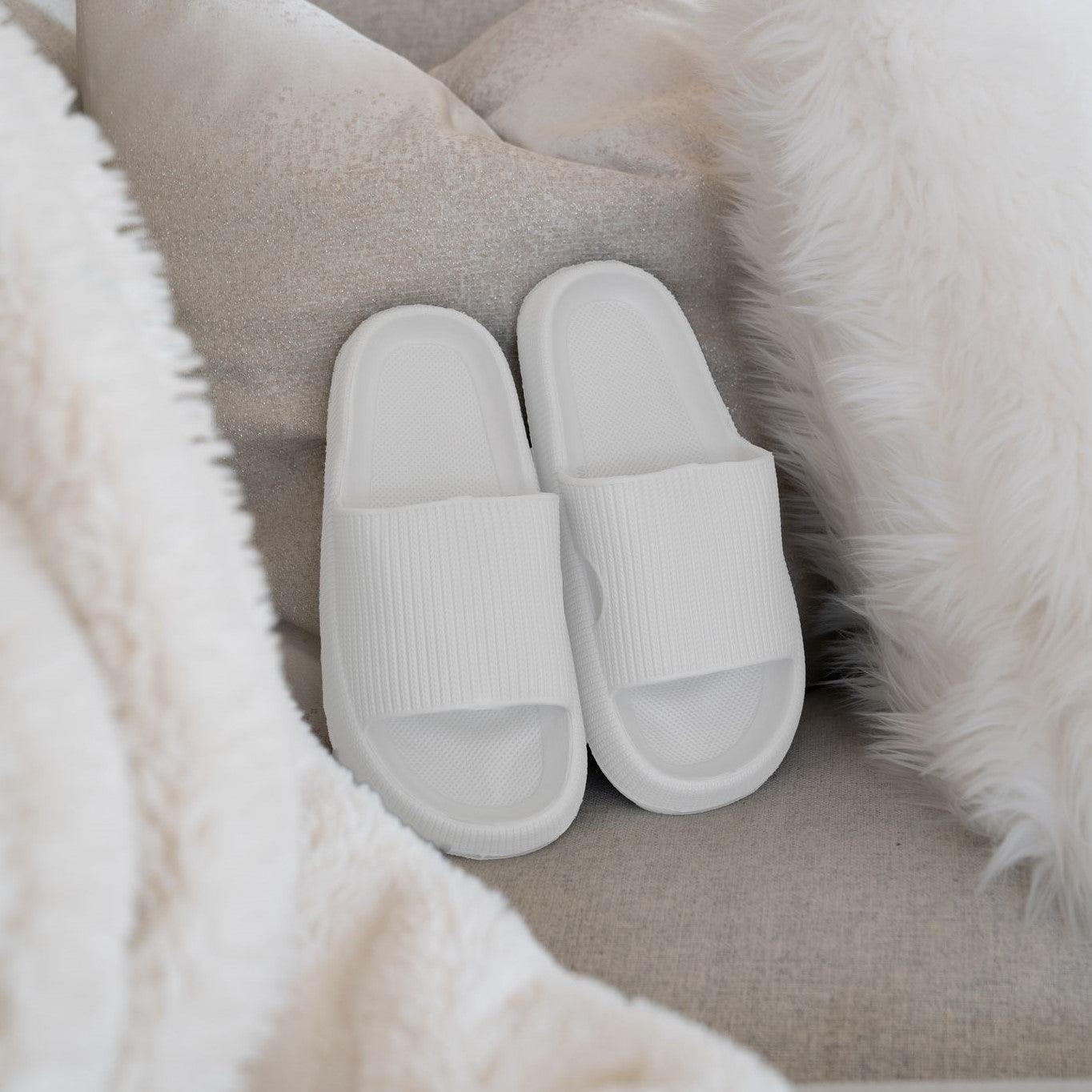 Men's white slides on couch