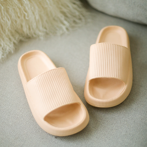 Comfortable tan slippers on couch